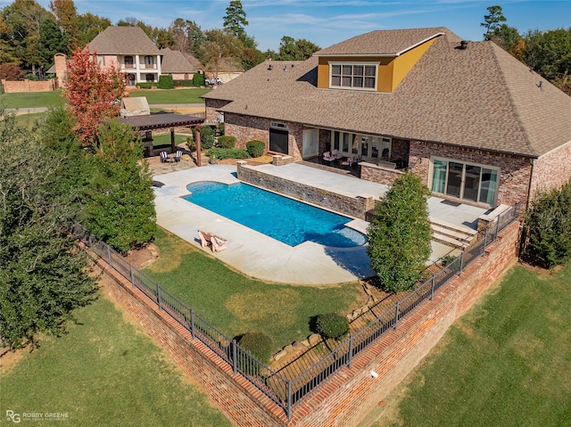 view of pool featuring a yard and a patio area