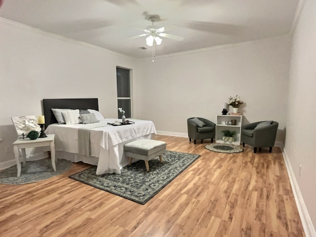 bedroom featuring ceiling fan, crown molding, and hardwood / wood-style flooring