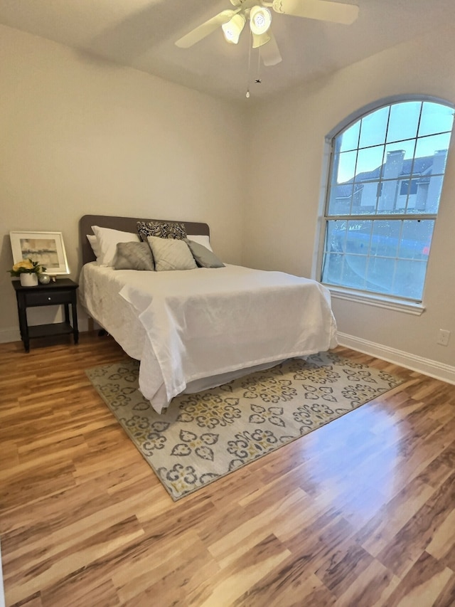 bedroom with ceiling fan and hardwood / wood-style floors