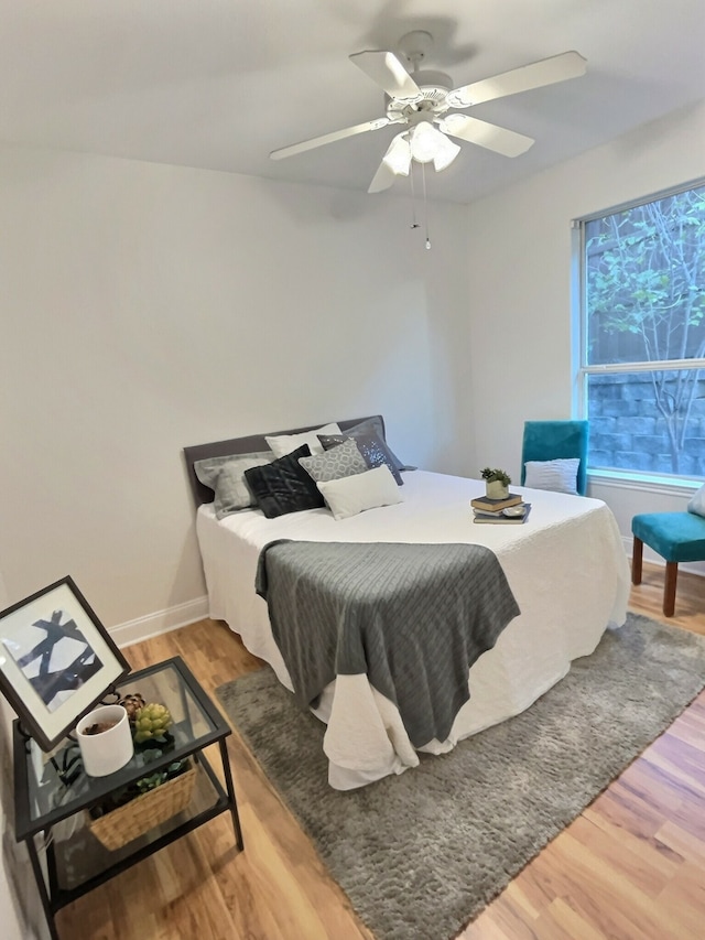 bedroom with hardwood / wood-style flooring and ceiling fan