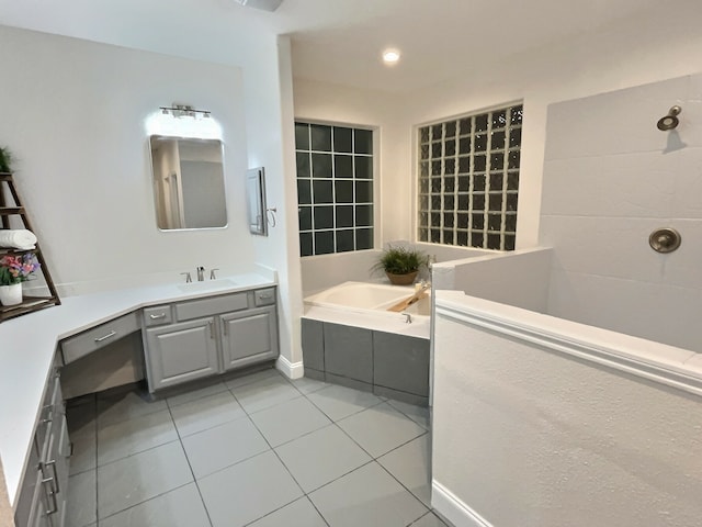 bathroom featuring tile patterned floors, a tub, and vanity