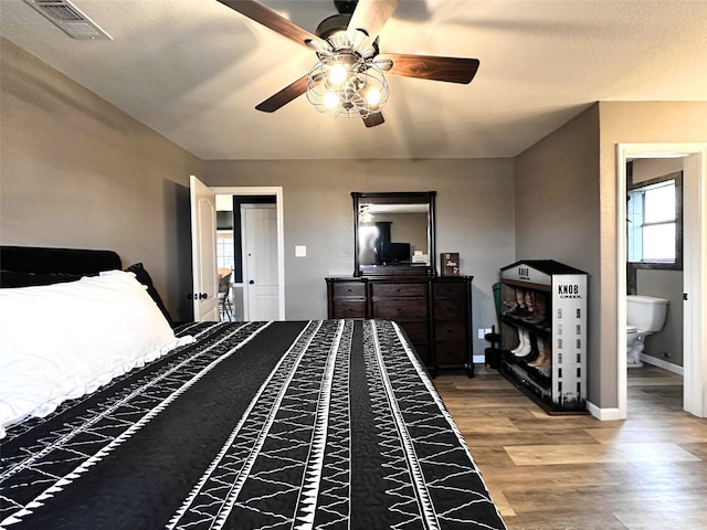 bedroom with wood-type flooring, ensuite bath, and ceiling fan