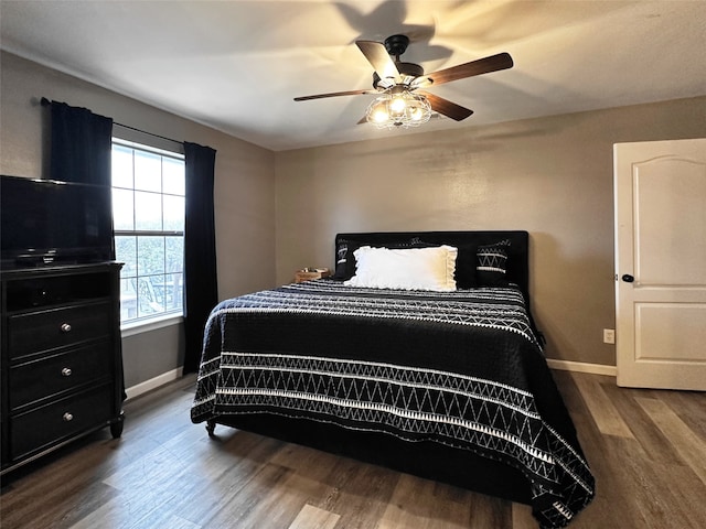 bedroom with ceiling fan and dark hardwood / wood-style flooring