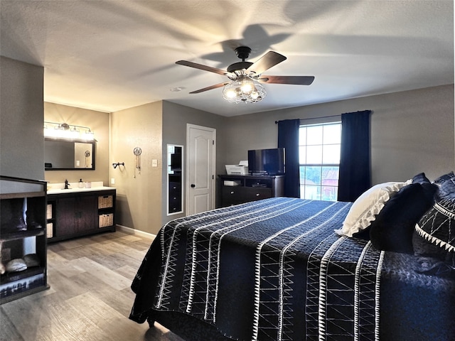 bedroom with ceiling fan and light hardwood / wood-style flooring