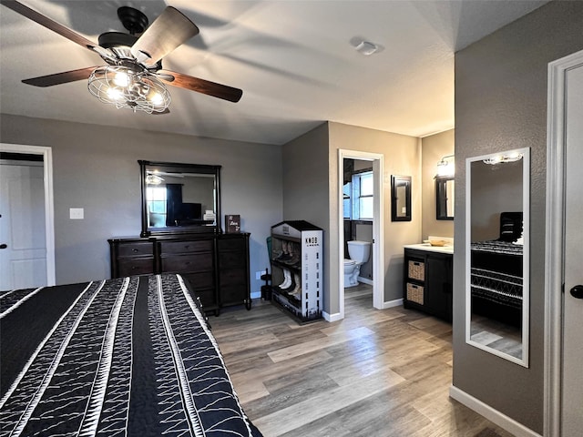 bedroom featuring wood-type flooring, connected bathroom, and ceiling fan