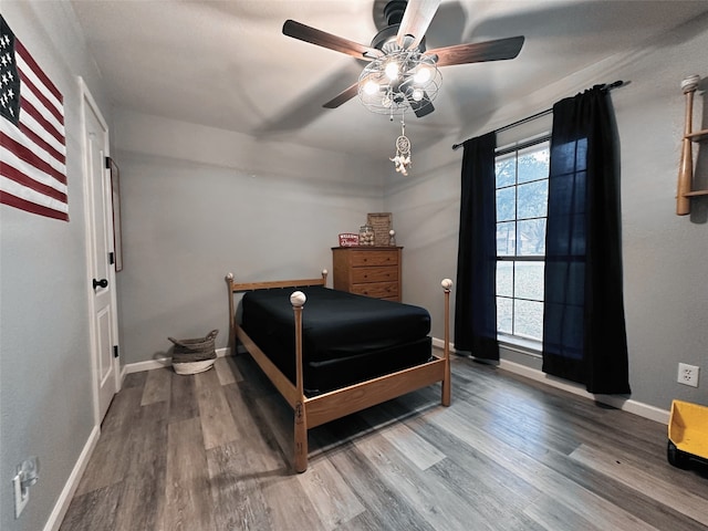 bedroom with ceiling fan and wood-type flooring