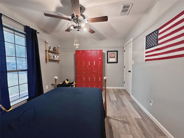 unfurnished bedroom with ceiling fan and wood-type flooring