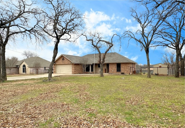 view of front of home with brick siding, an attached garage, a front yard, and fence