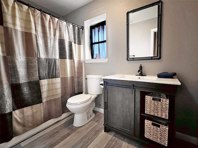 bathroom with a shower with shower curtain, wood-type flooring, vanity, and toilet