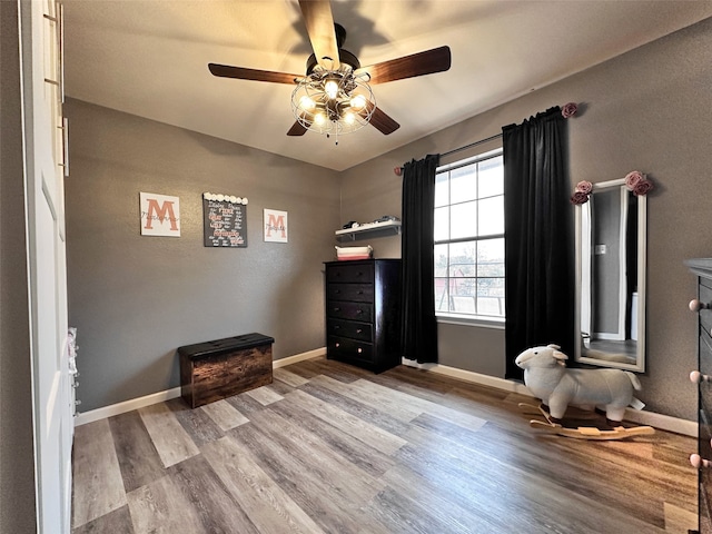 bedroom with light hardwood / wood-style floors and ceiling fan