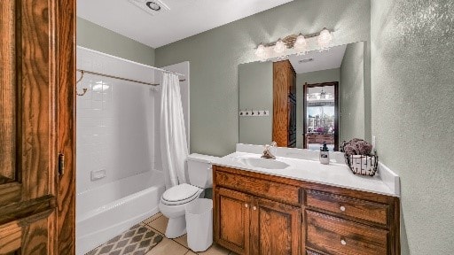 full bathroom featuring tile patterned flooring, shower / tub combo, vanity, and toilet