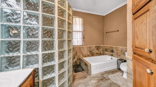 full bathroom with ornamental molding, vanity, tile walls, independent shower and bath, and toilet