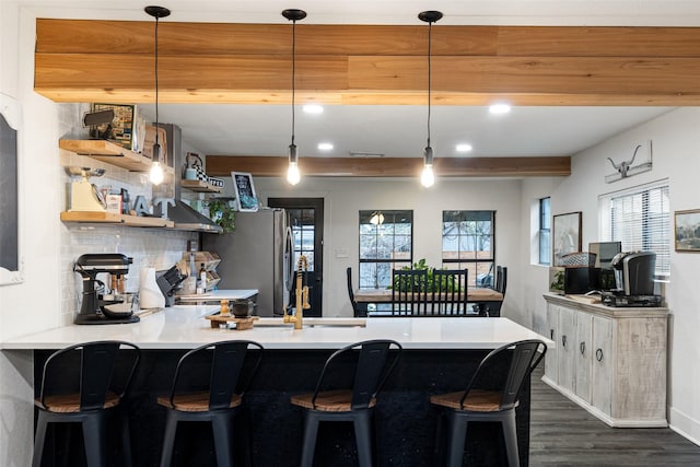 kitchen with pendant lighting, plenty of natural light, and a kitchen bar