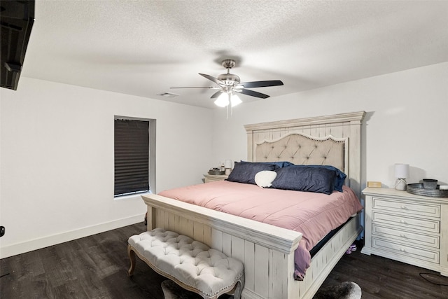 bedroom with a textured ceiling, ceiling fan, and dark hardwood / wood-style floors