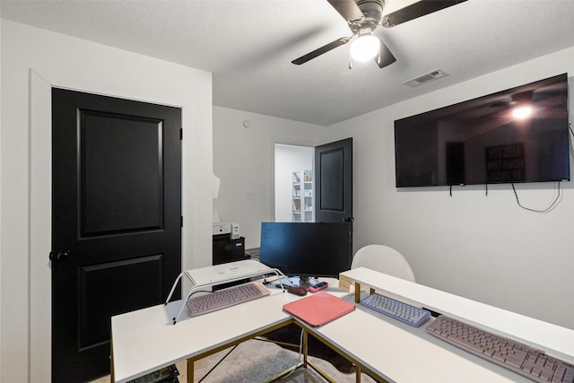 home office with ceiling fan and a textured ceiling