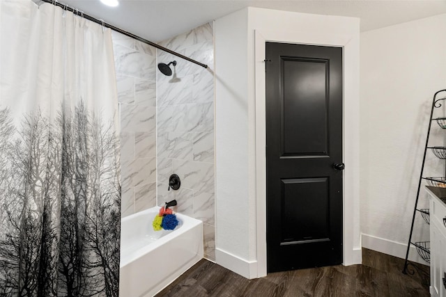 bathroom featuring hardwood / wood-style floors and shower / bathtub combination with curtain