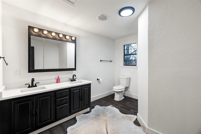 bathroom featuring hardwood / wood-style flooring, vanity, and toilet