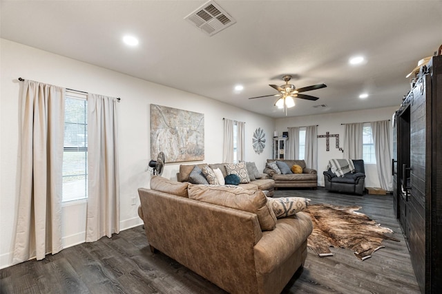 living room featuring dark hardwood / wood-style floors and ceiling fan