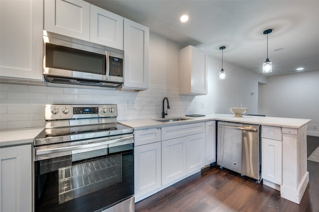 kitchen with pendant lighting, stainless steel appliances, white cabinetry, and sink