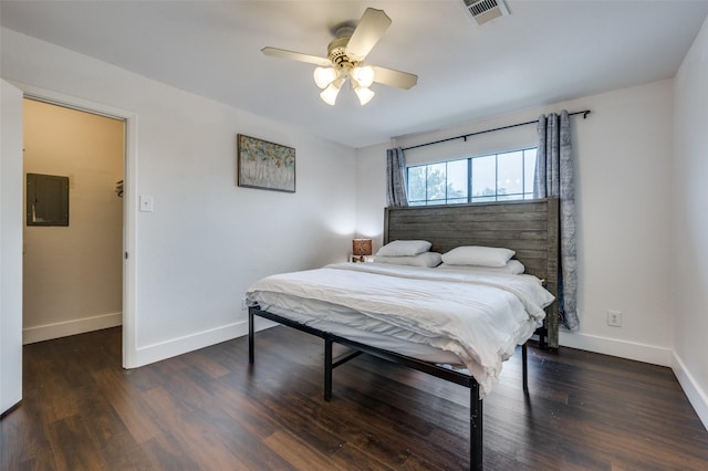 bedroom featuring ceiling fan, dark wood-type flooring, and electric panel