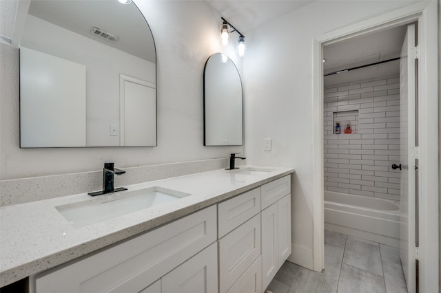 bathroom featuring vanity and tiled shower / bath combo