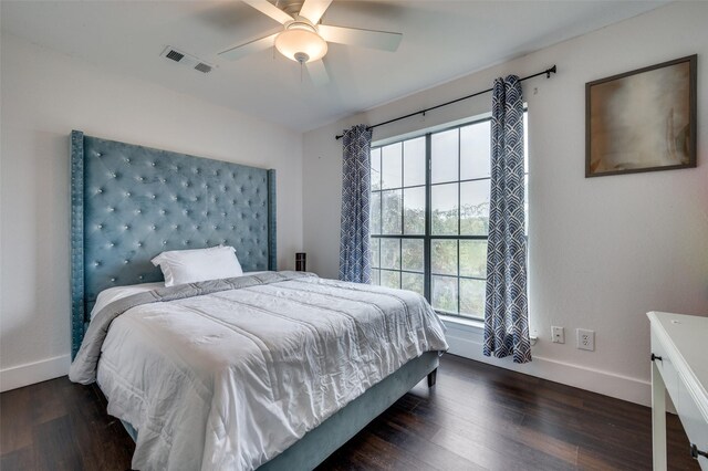 bedroom featuring multiple windows, ceiling fan, and dark wood-type flooring