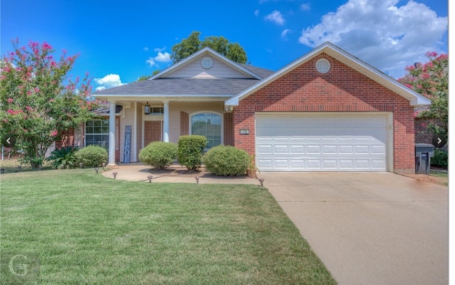 view of front of property featuring a front yard and a garage