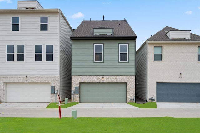 view of front of home with a front yard and a garage