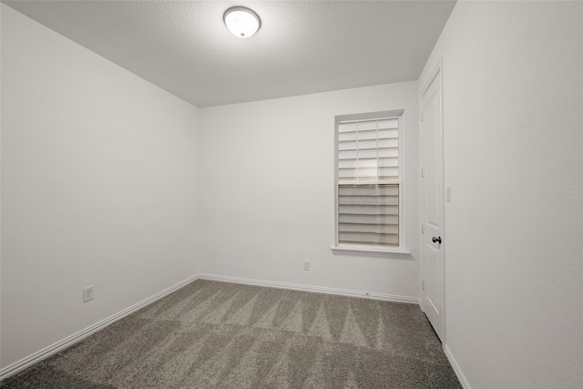 carpeted spare room with a textured ceiling