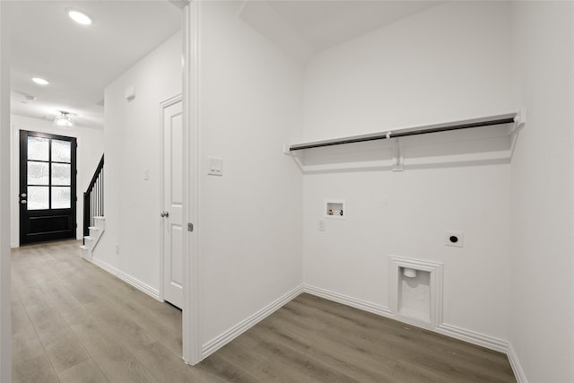 clothes washing area featuring hookup for an electric dryer, hookup for a washing machine, and light wood-type flooring