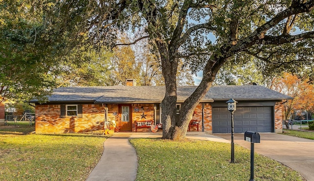 ranch-style home featuring a garage and a front yard