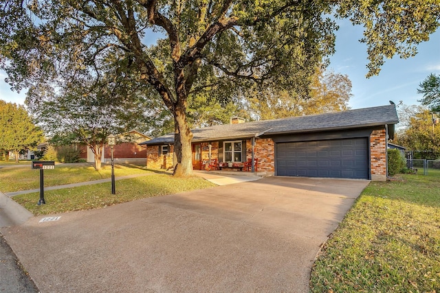 single story home with a front yard and a garage