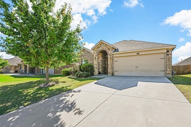 view of front of house with a front yard and a garage