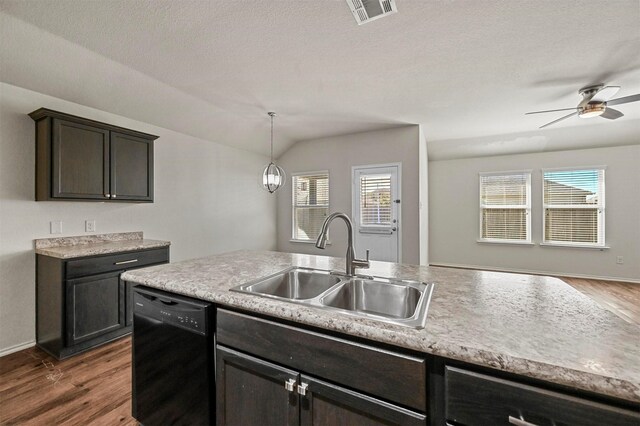 kitchen featuring dishwasher, sink, vaulted ceiling, dark hardwood / wood-style floors, and decorative light fixtures