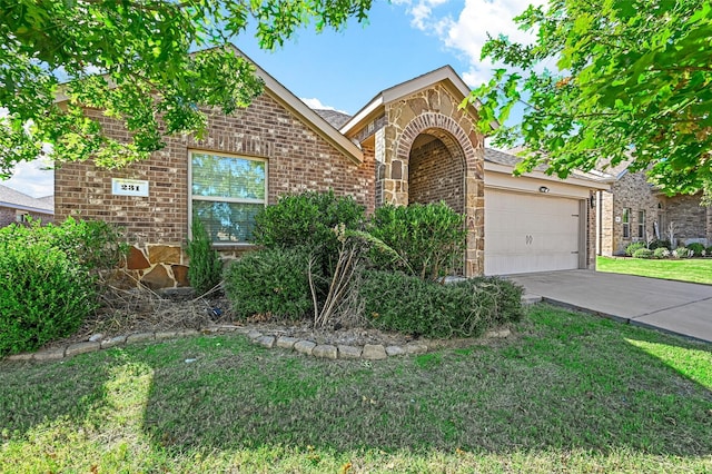 view of front of house with a front yard and a garage