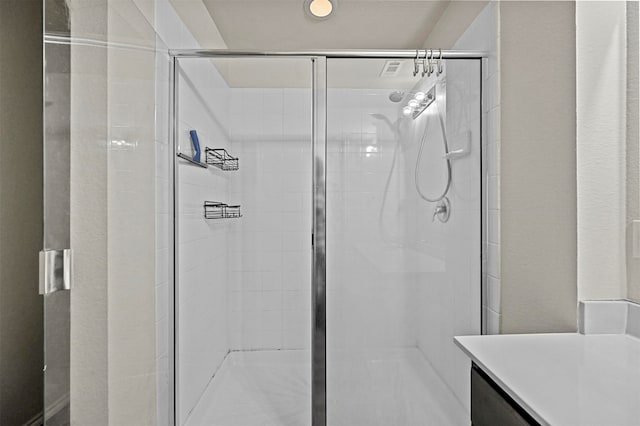 bathroom with a shower with shower door