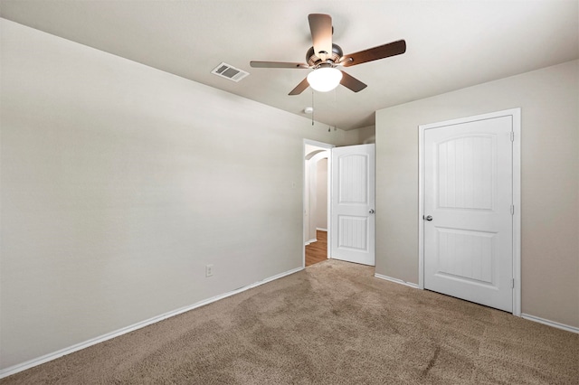 unfurnished bedroom featuring ceiling fan and light colored carpet