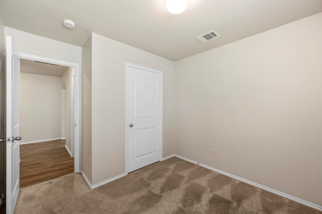 unfurnished bedroom with a closet and carpet floors