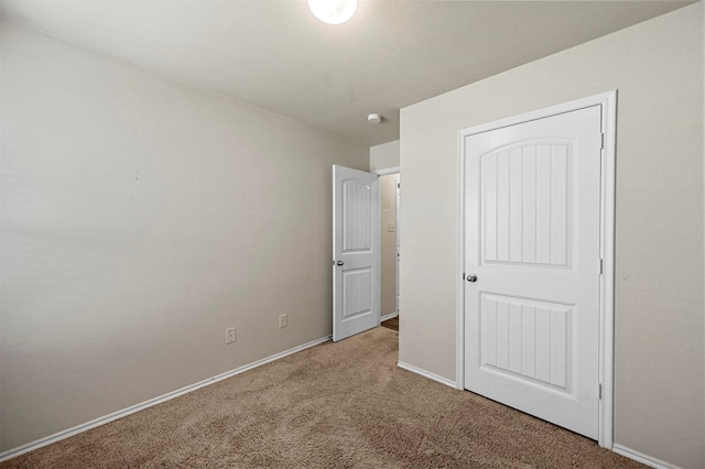 unfurnished bedroom with carpet flooring