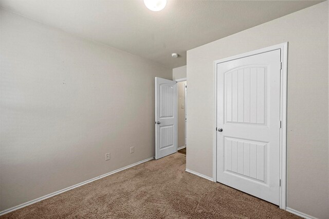 unfurnished bedroom with carpet flooring