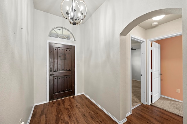 foyer entrance featuring dark hardwood / wood-style flooring and an inviting chandelier