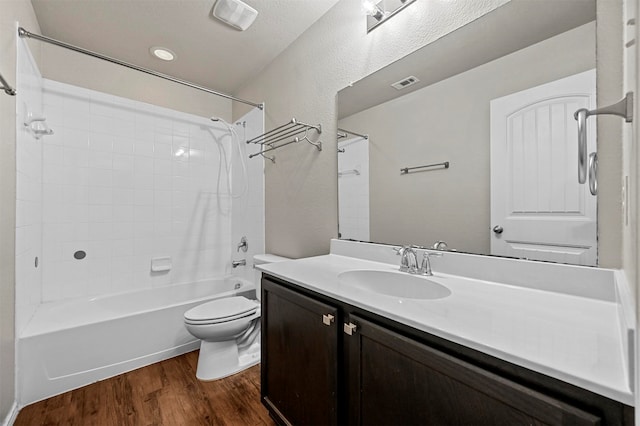 full bathroom with shower / bath combination, vanity, wood-type flooring, and toilet