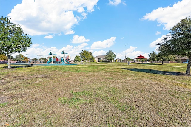 exterior space with a playground, a yard, and a gazebo