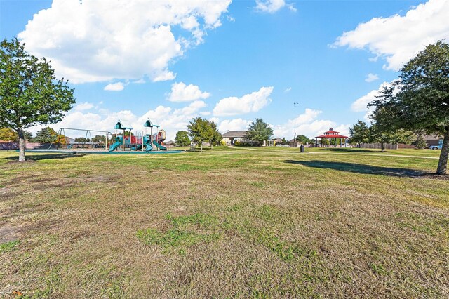 exterior space with a playground, a yard, and a gazebo