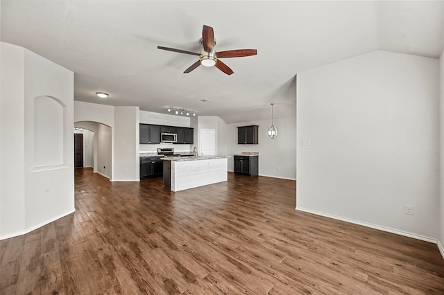 unfurnished living room featuring ceiling fan, dark hardwood / wood-style flooring, and sink