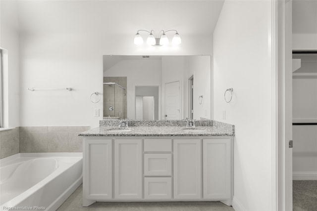 bathroom with vanity and independent shower and bath