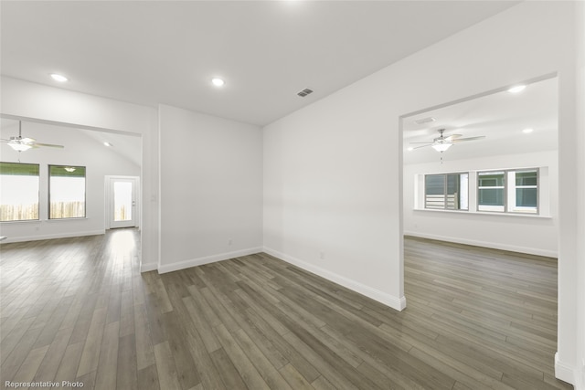 empty room featuring ceiling fan, dark hardwood / wood-style flooring, and lofted ceiling