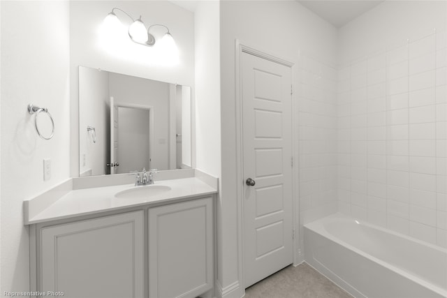 bathroom featuring vanity, tile patterned flooring, and tiled shower / bath