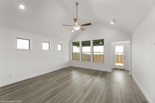 empty room featuring lofted ceiling, ceiling fan, and dark hardwood / wood-style floors