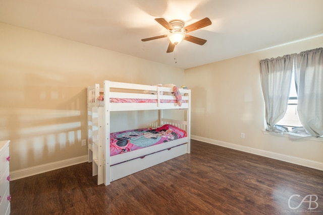 bedroom with dark hardwood / wood-style flooring and ceiling fan